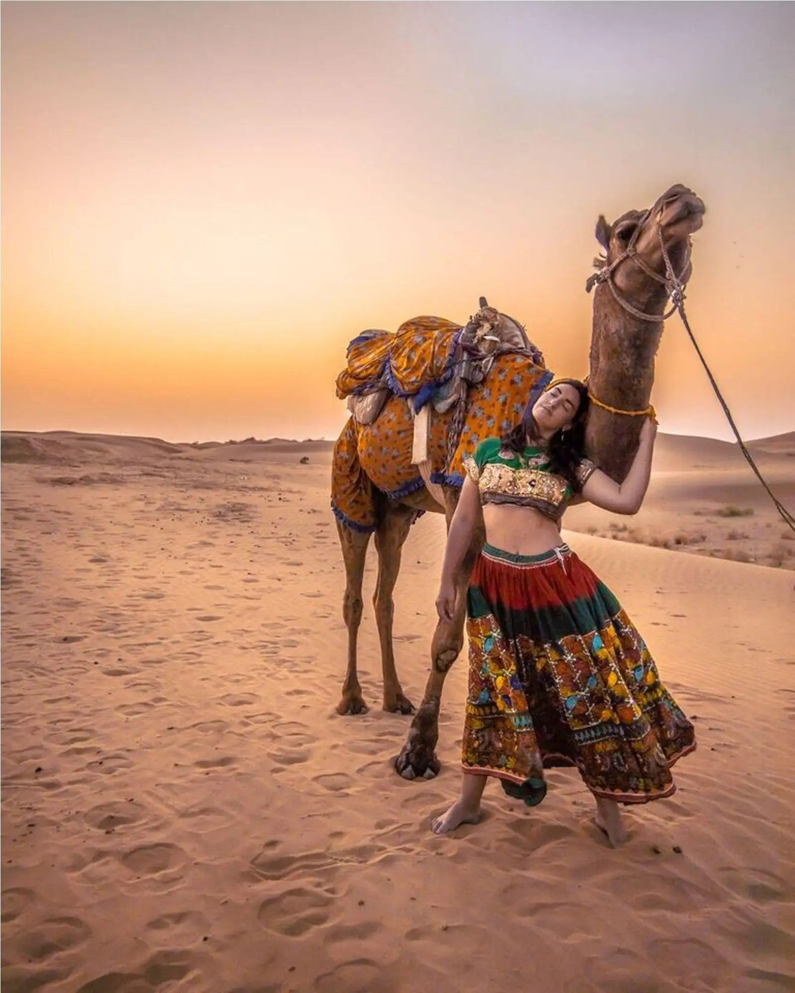 Tourist enjoying camel safari in Jaisalmer desert at Sam Sand Dunes